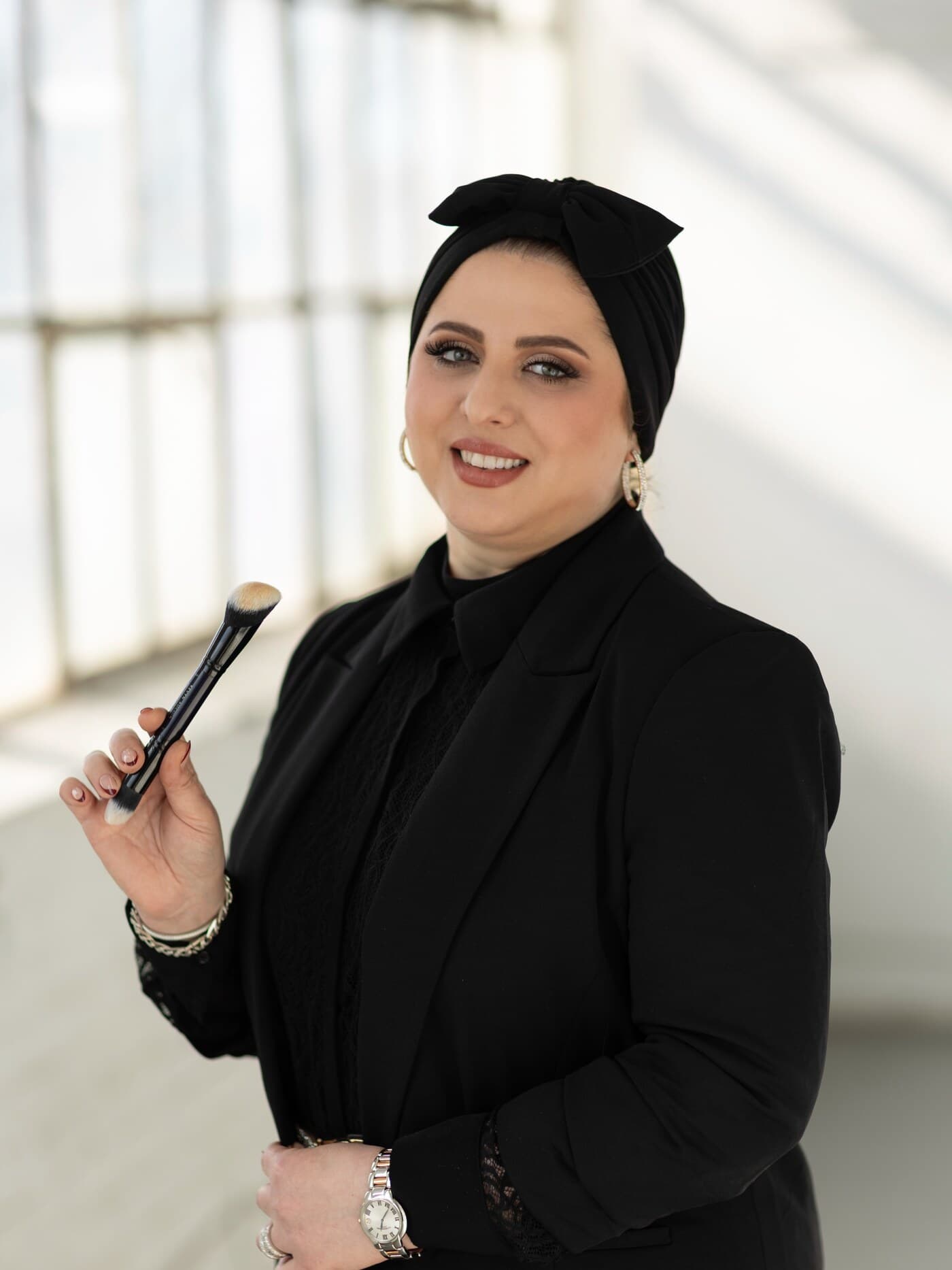Malaz, bridal makeup artist serving NJ, NY, CT and PA, professional portrait with makeup brush