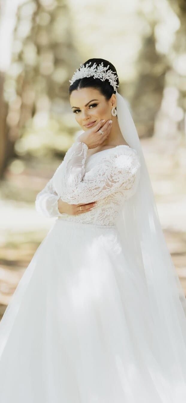 Seated bride in gown with elegant bridal makeup