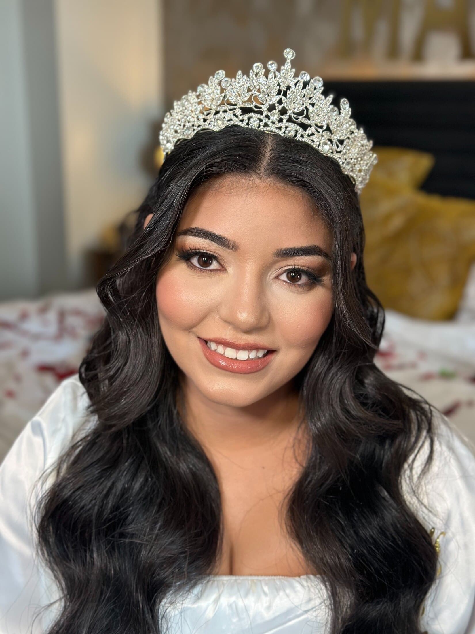 Smiling bride with tiara and luminous bridal makeup