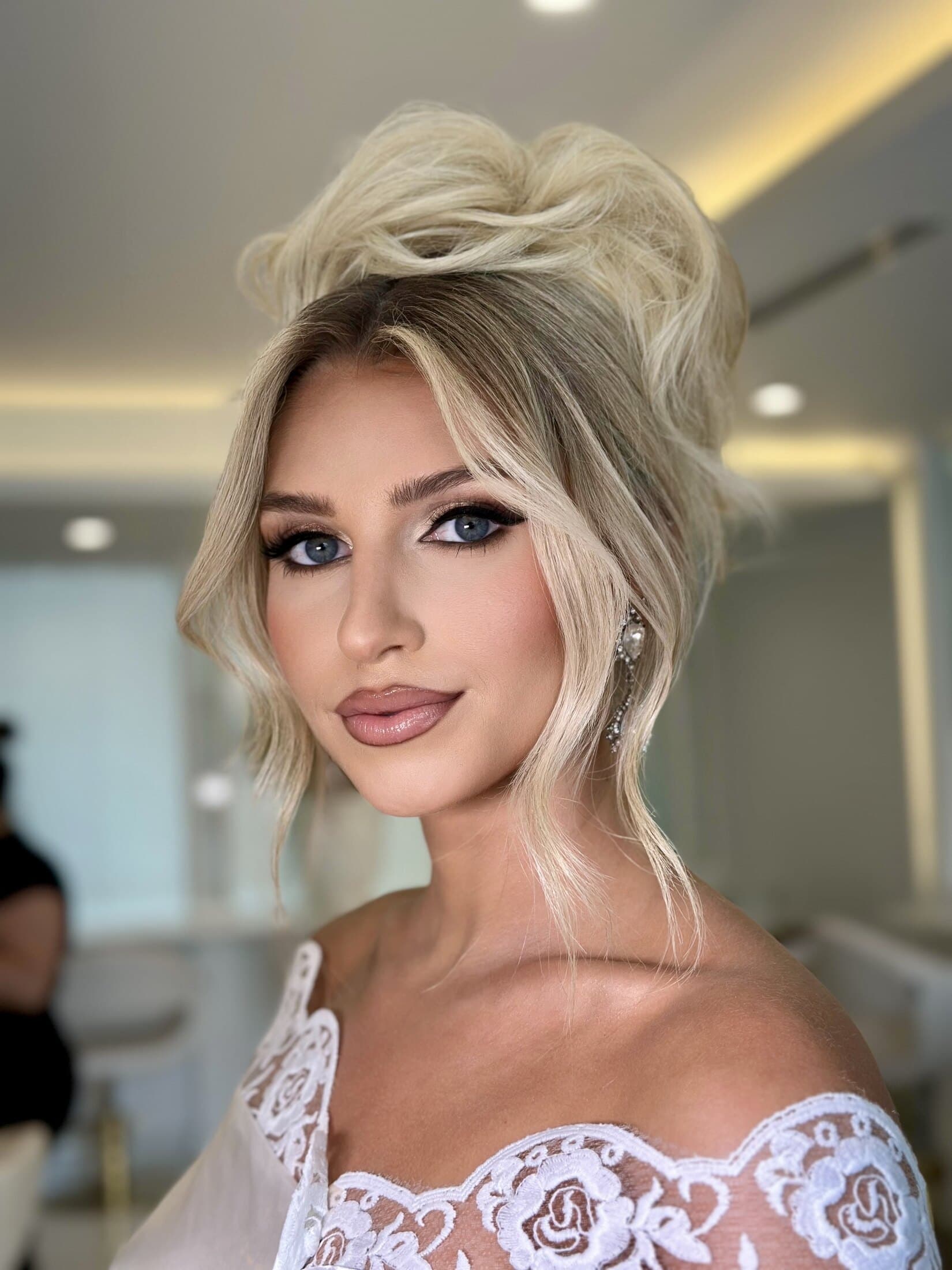Sleek polished updo with glam makeup