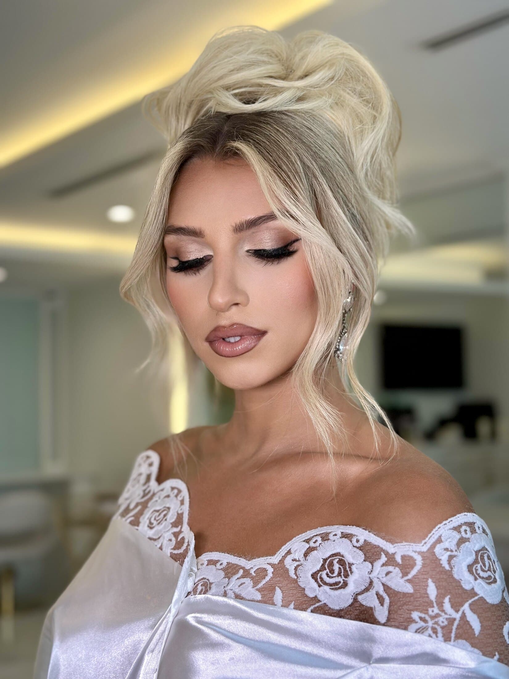 Elegant high bun with soft glam makeup